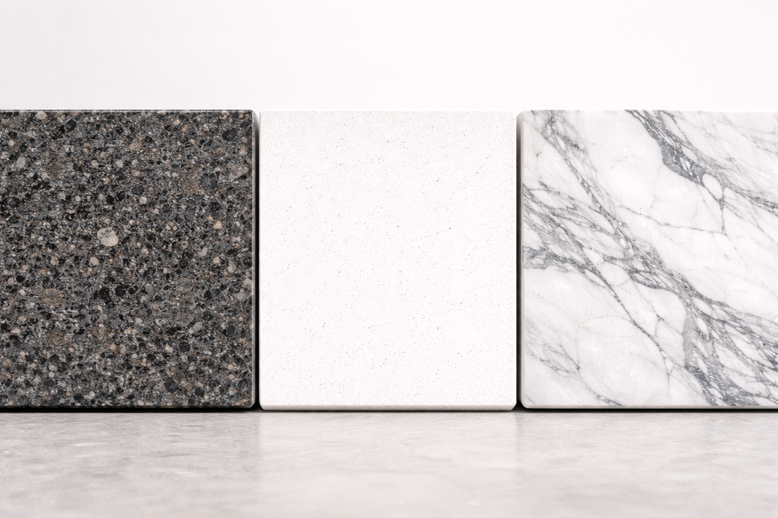 Close-up detail comparison of granite, quartz, and marble surface textures for contractor stone selection